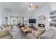 Bright and airy living room with a fireplace, large windows, and comfortable seating for a welcoming atmosphere at 3134 Milloak Ct, Buford, GA 30519