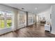 Bright living room with large windows, hardwood floors, and an adjacent dining area with modern light fixture at 3134 Milloak Ct, Buford, GA 30519
