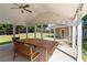 Covered patio with a ceiling fan, string lights, large picnic table, and nice view of backyard at 3134 Milloak Ct, Buford, GA 30519