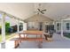 View of covered patio with ceiling fan, string lights, and plenty of space for dining and entertaining at 3134 Milloak Ct, Buford, GA 30519