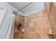 Close up of the tiled shower stall with shower caddy, shower head, and shower curtain at 3134 Milloak Ct, Buford, GA 30519