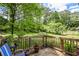 Relaxing backyard deck with lush greenery, potted plants, seating, and a peaceful view for outdoor enjoyment at 3739 Lake Carlton Rd, Loganville, GA 30052