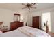 Comfortable bedroom featuring a ceiling fan, ample storage, and neutral color scheme, creating a relaxing atmosphere at 3739 Lake Carlton Rd, Loganville, GA 30052