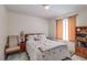 Inviting bedroom with a comfortable bed, natural light, and a cozy chair, offering a pleasant and relaxing space at 3739 Lake Carlton Rd, Loganville, GA 30052