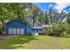 Charming blue home featuring a well-manicured lawn and an inviting entrance walkway at 3739 Lake Carlton Rd, Loganville, GA 30052