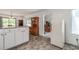 Well-lit kitchen area with white cabinets and views into the dining and living rooms at 3739 Lake Carlton Rd, Loganville, GA 30052