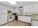 Functional kitchen with white cabinets, granite countertops, and modern appliances at 3739 Lake Carlton Rd, Loganville, GA 30052