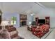 Spacious living room with a stone fireplace, high ceilings, and a ceiling fan at 3739 Lake Carlton Rd, Loganville, GA 30052
