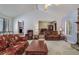 Open-concept living room featuring plush seating, a fireplace, and access to the dining area at 3739 Lake Carlton Rd, Loganville, GA 30052