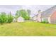 Lush backyard with green lawn, shed, partial fence, and a view of the home's rear at 1016 E Bay Springs Dr, Villa Rica, GA 30180