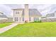Spacious backyard featuring a well-maintained lawn, patio, and fenced perimeter at 1016 E Bay Springs Dr, Villa Rica, GA 30180