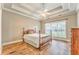 Cozy bedroom with trey ceiling, ceiling fan, wood floors, and natural light at 1016 E Bay Springs Dr, Villa Rica, GA 30180
