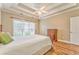 Bright bedroom featuring tray ceiling, wood floors, and a large window at 1016 E Bay Springs Dr, Villa Rica, GA 30180