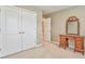 Bedroom with antique vanity and closet with double doors at 1016 E Bay Springs Dr, Villa Rica, GA 30180