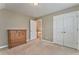 Bedroom featuring neutral walls, a wooden dresser, and carpeted floors at 1016 E Bay Springs Dr, Villa Rica, GA 30180