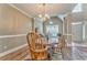 Elegant dining room featuring wood floors, modern lighting, and a bright window view at 1016 E Bay Springs Dr, Villa Rica, GA 30180