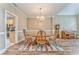 Charming dining area with hardwood floors, decorative rug, chandelier and adjacent piano at 1016 E Bay Springs Dr, Villa Rica, GA 30180