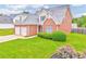 All brick two-story home with an attached two car garage, manicured lawn and well kept landscaping at 1016 E Bay Springs Dr, Villa Rica, GA 30180