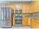 Contemporary kitchen with stainless steel appliances and wooden cabinetry providing efficient layout at 1016 E Bay Springs Dr, Villa Rica, GA 30180