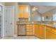 Well-lit kitchen with stainless steel dishwasher, wooden cabinets, and granite countertops at 1016 E Bay Springs Dr, Villa Rica, GA 30180