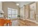 Bright living room featuring wood floors, high ceilings, large windows and plant accents at 1016 E Bay Springs Dr, Villa Rica, GA 30180