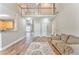 Open-concept living room featuring wood floors, neutral paint, and a view of the second floor at 1016 E Bay Springs Dr, Villa Rica, GA 30180