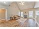 Cozy living room with fireplace, large windows, hardwood floors, and comfortable seating at 1016 E Bay Springs Dr, Villa Rica, GA 30180