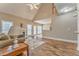 Bright living room with wood floors, fireplace, and vaulted ceiling leads to the kitchen at 1016 E Bay Springs Dr, Villa Rica, GA 30180