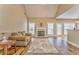 Inviting living room features a fireplace, neutral paint, vaulted ceiling, and wood floors at 1016 E Bay Springs Dr, Villa Rica, GA 30180