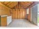 The shed has shelving, a peg board, concrete flooring, and a window for convenient storage of tools and equipment at 1016 E Bay Springs Dr, Villa Rica, GA 30180