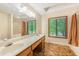 Double sink bathroom featuring a window, a tub, and beige tiling at 1359 Cedar Park Pl, Stone Mountain, GA 30083