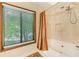 Neutral bathroom featuring a bathtub and tiled shower with a rainfall shower head at 1359 Cedar Park Pl, Stone Mountain, GA 30083