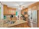 Updated kitchen featuring granite countertops, stainless steel appliances, and a breakfast bar at 1359 Cedar Park Pl, Stone Mountain, GA 30083