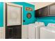 Bright laundry room featuring modern appliances, stylish decor, and ample storage space at 1359 Cedar Park Pl, Stone Mountain, GA 30083