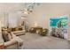 Spacious living room with neutral carpeting, cozy seating, and an open view to the dining area at 1359 Cedar Park Pl, Stone Mountain, GA 30083