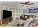 Comfortable living room with a plush leather sofa, entertainment center, and cozy gray carpet at 1359 Cedar Park Pl, Stone Mountain, GA 30083