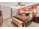 Spacious main bedroom with a tufted headboard, a ceiling fan, and a window at 1359 Cedar Park Pl, Stone Mountain, GA 30083