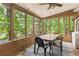 Relaxing sunroom with ceiling fan and many windows showcasing the outdoor greenery at 1359 Cedar Park Pl, Stone Mountain, GA 30083