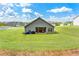 Back view of home with a covered patio, a grill, and a large grassy yard at 426 Samara Ct, Fairburn, GA 30213
