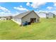 Wide backyard with large lawn, patio, grill, and views of nearby homes at 426 Samara Ct, Fairburn, GA 30213