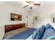 Bedroom featuring a television, ceiling fan, and blue bedding at 426 Samara Ct, Fairburn, GA 30213