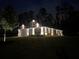 Exterior home view with elegant outdoor lighting showcasing architectural details, enhancing curb appeal in the dark at 426 Samara Ct, Fairburn, GA 30213