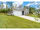 Well-maintained single-story home with a lush lawn, inviting curb appeal, and an attached two-car garage at 426 Samara Ct, Fairburn, GA 30213
