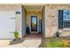 Close-up of the home's entrance featuring a charming welcome sign, brick accents, and covered porch at 426 Samara Ct, Fairburn, GA 30213