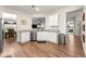 Bright kitchen with stainless steel appliances, white cabinets, granite countertop and wooden flooring at 426 Samara Ct, Fairburn, GA 30213