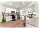 Modern kitchen featuring stainless appliances, granite counters, white cabinets, and wood-look floors at 426 Samara Ct, Fairburn, GA 30213