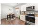 Modern kitchen area featuring stainless steel appliances, granite countertops, and a cozy breakfast nook at 426 Samara Ct, Fairburn, GA 30213