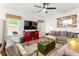 Comfortable living room featuring a large TV, gray sofa, colorful accents, and modern decor at 426 Samara Ct, Fairburn, GA 30213