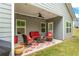 Covered patio with string lights, fan, and outdoor furniture with a red color scheme at 426 Samara Ct, Fairburn, GA 30213