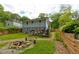 Spacious backyard featuring a firepit area and mature trees, perfect for outdoor entertaining at 569 Woods Nw Dr, Atlanta, GA 30318